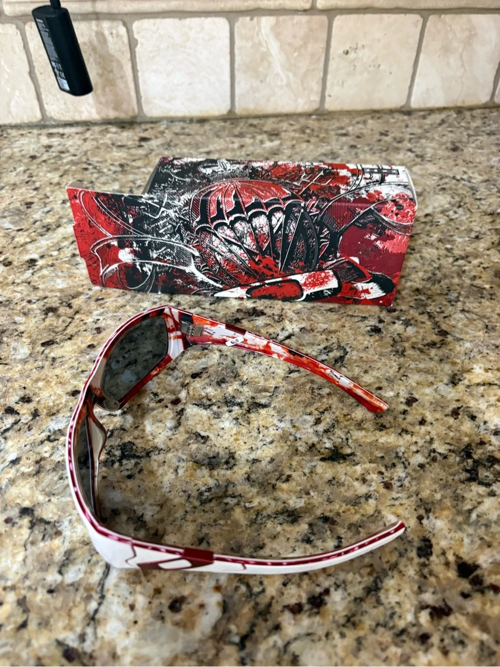 Oakley White Frame Sunglasses with Red Patterned Temples and Dark Lenses